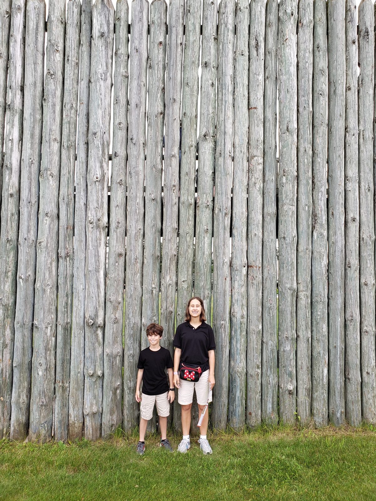 The kids against the fort's palisade wall