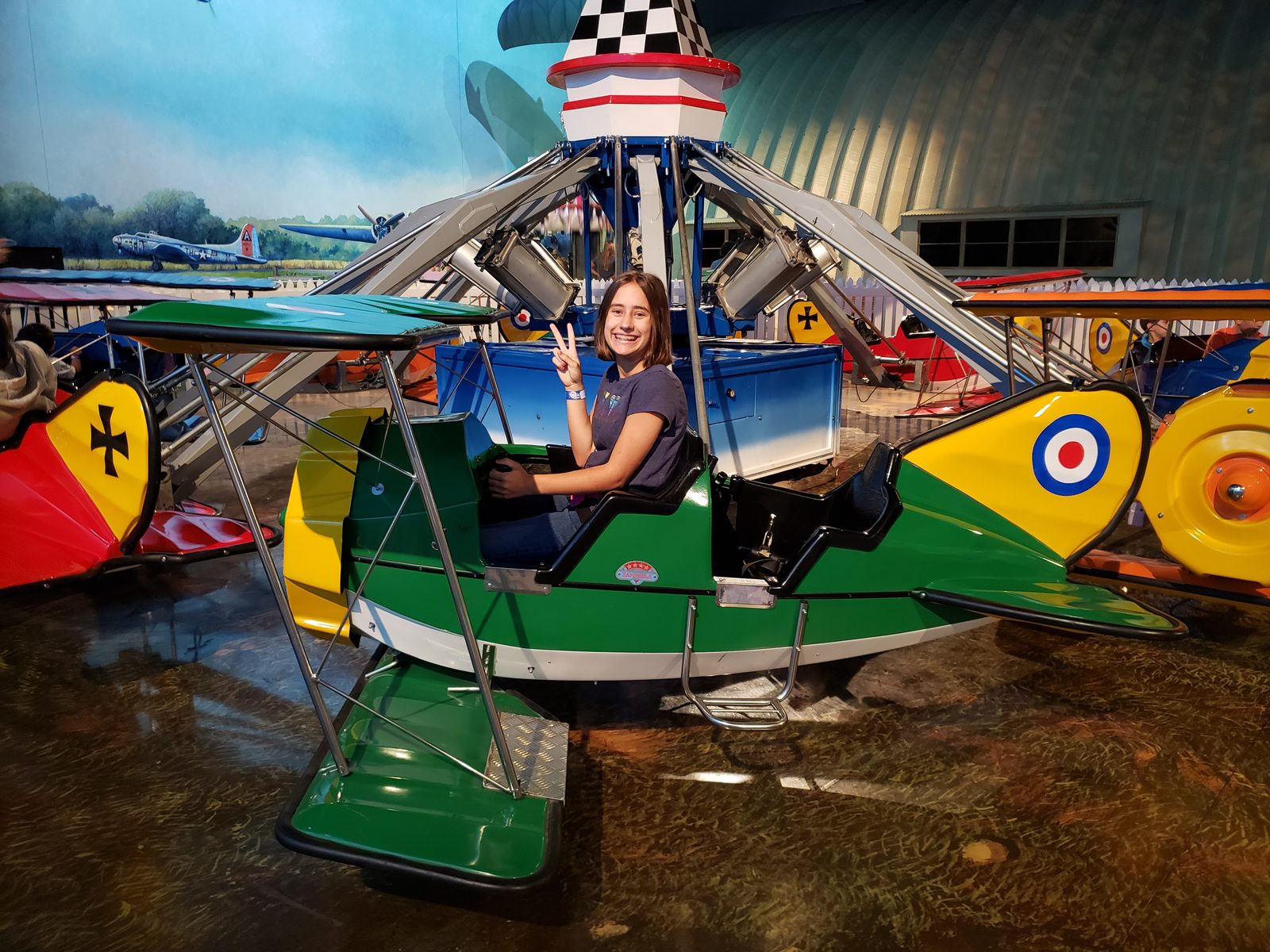 Lisa flying a little plane at the Air Zoo