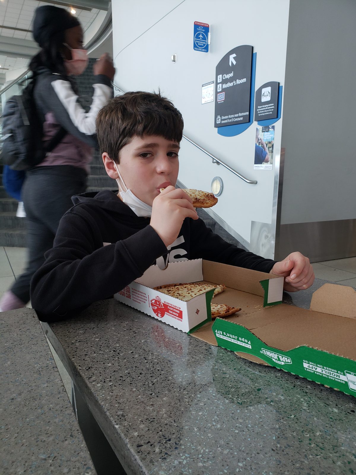 Thomas grabs pizza during our layover in Charlotte