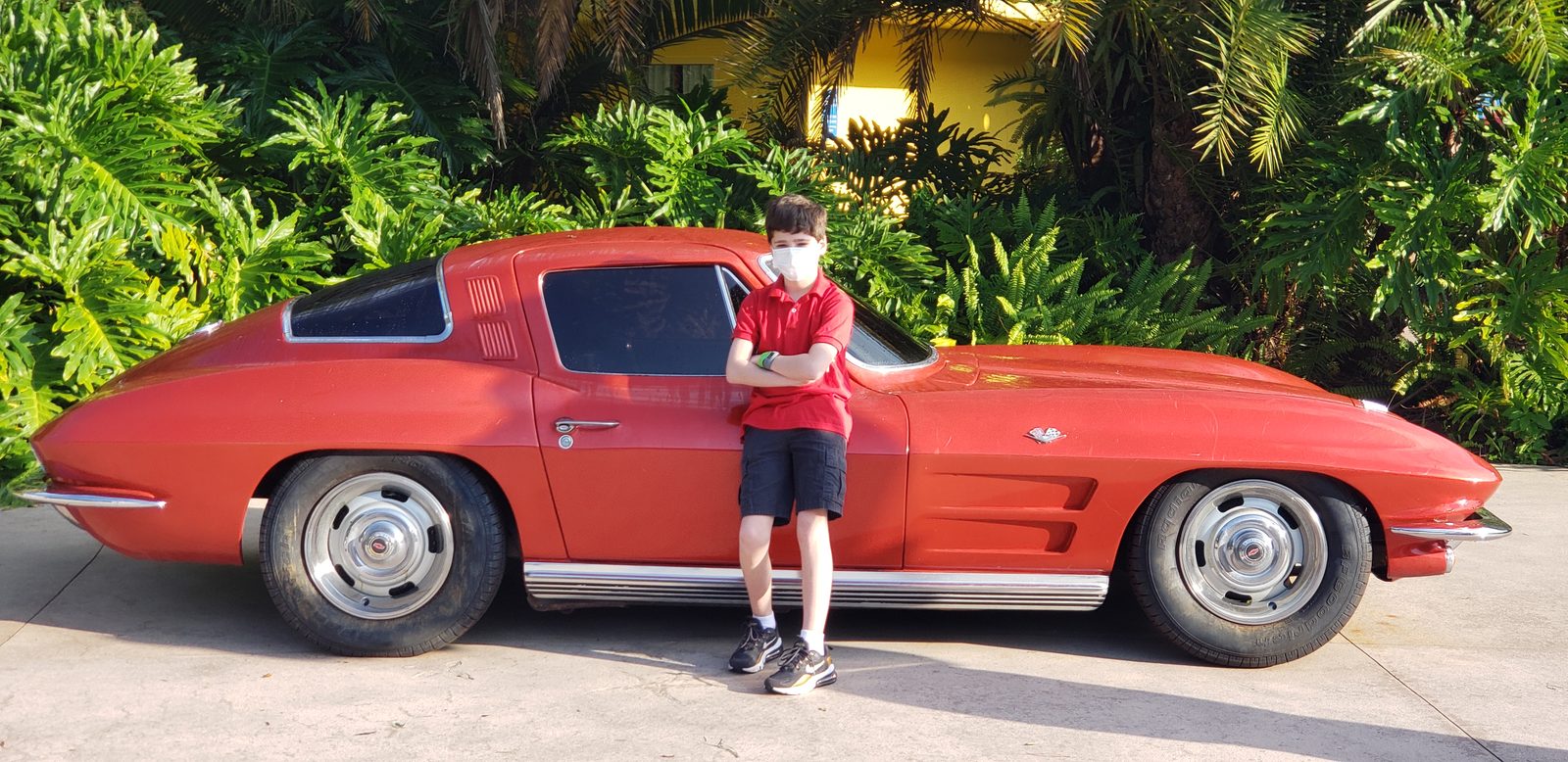 Thomas next to the vintage Corvette outside Test Track