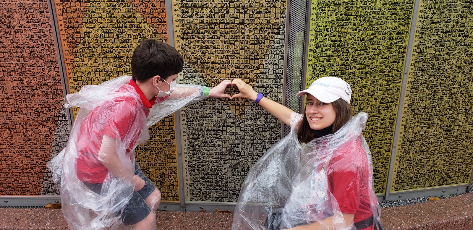 Thomas and Lisa making a heart over our tile, in rain ponchos