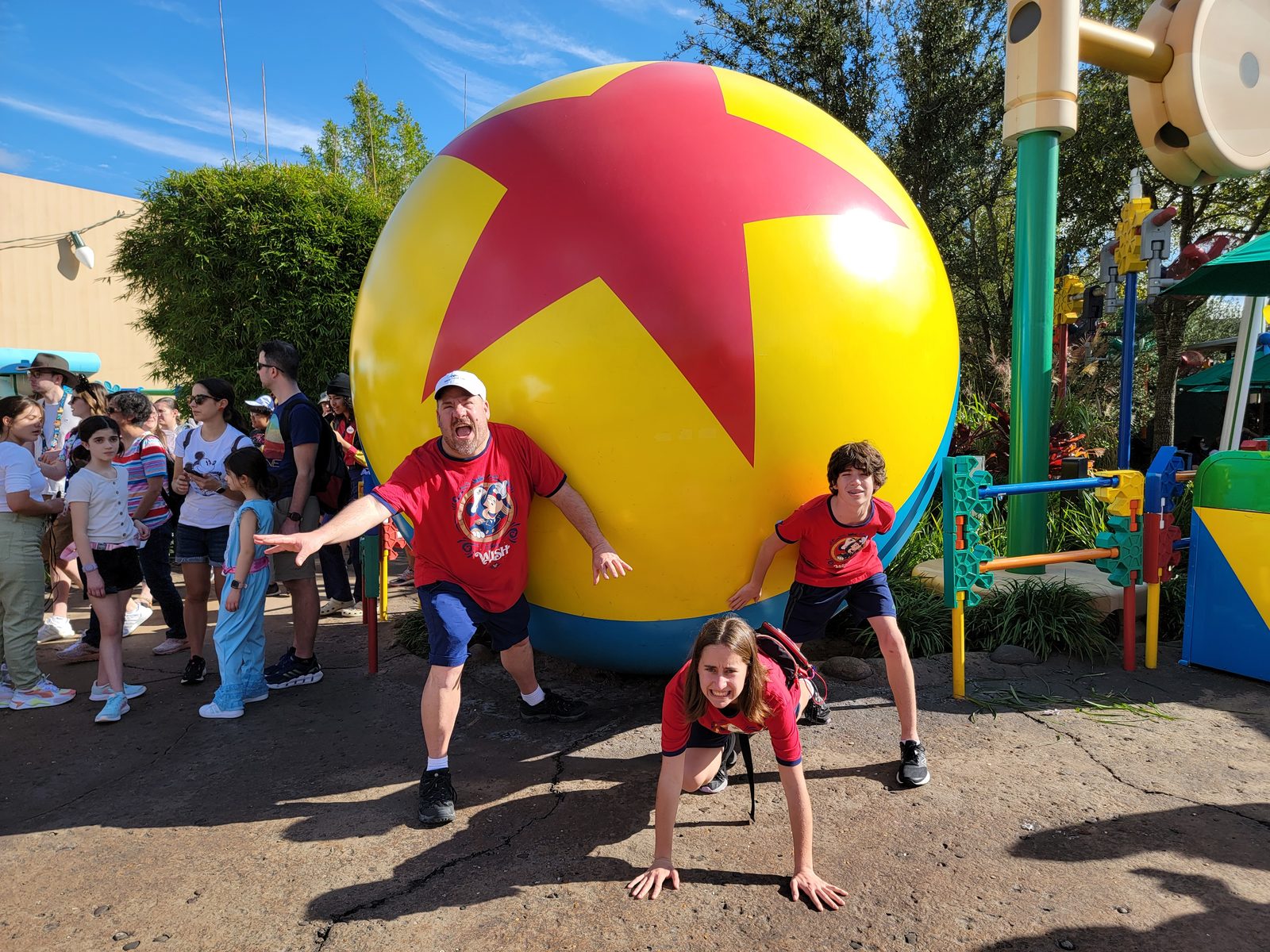 Michael, Lisa and Thomas holding back the Pixar ball in Toy Story Land