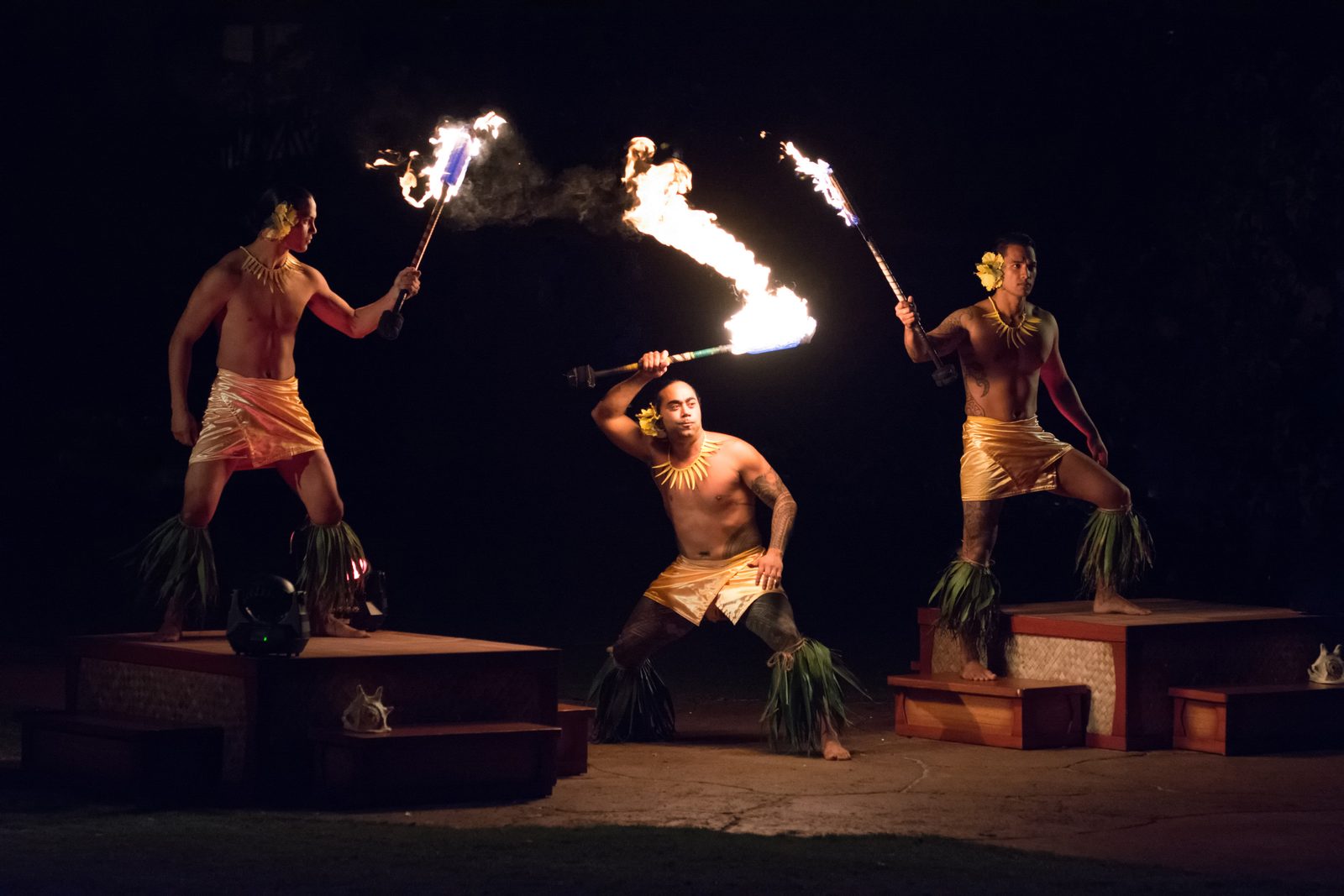 Three dancers with fire at the luau