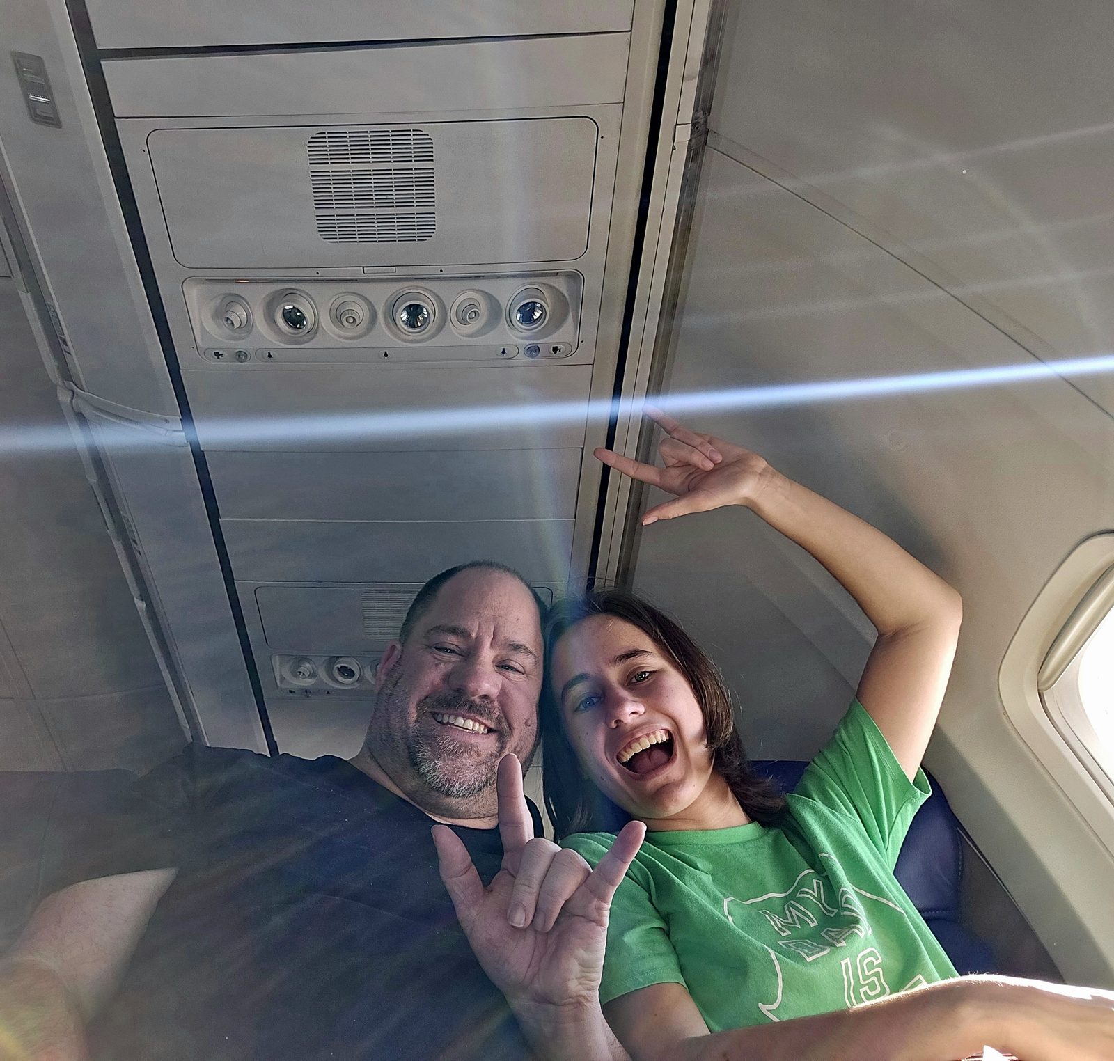Lisa and Michael signing I love you on the flight to San Diego
