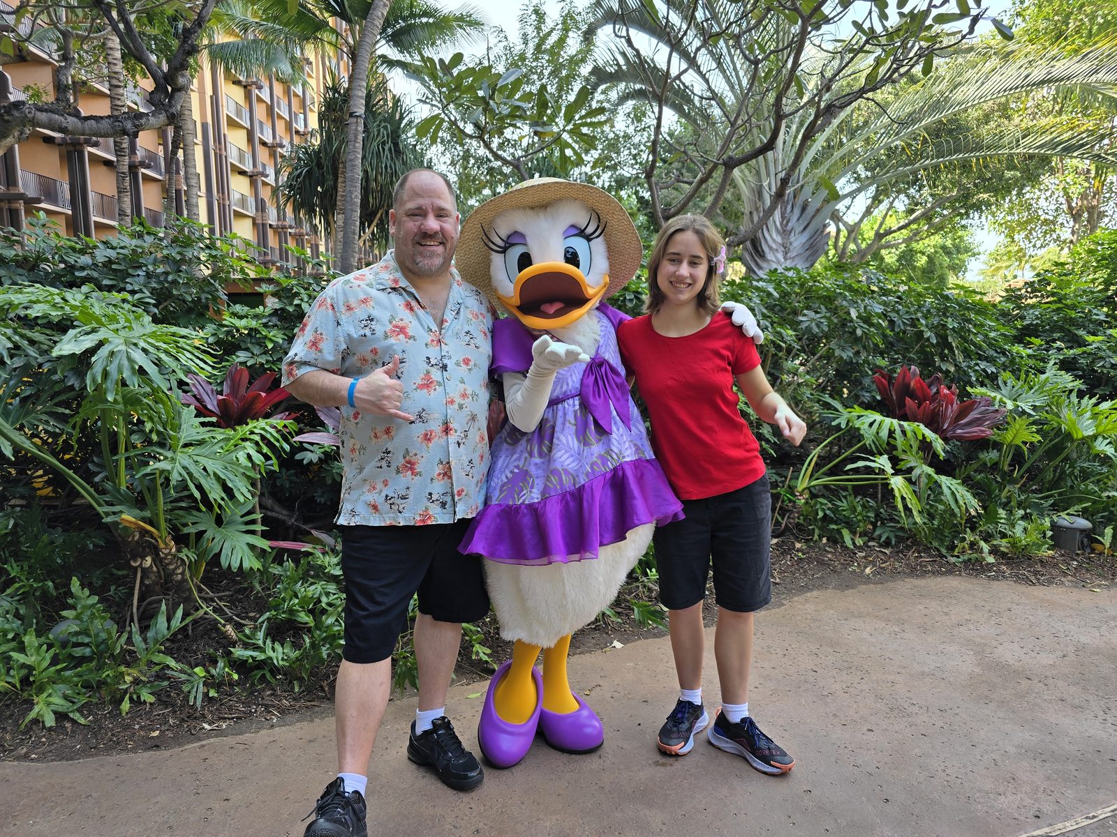 Michael, Daisy Duck in her purple sundress and sun hat and Lisa at Aulani
