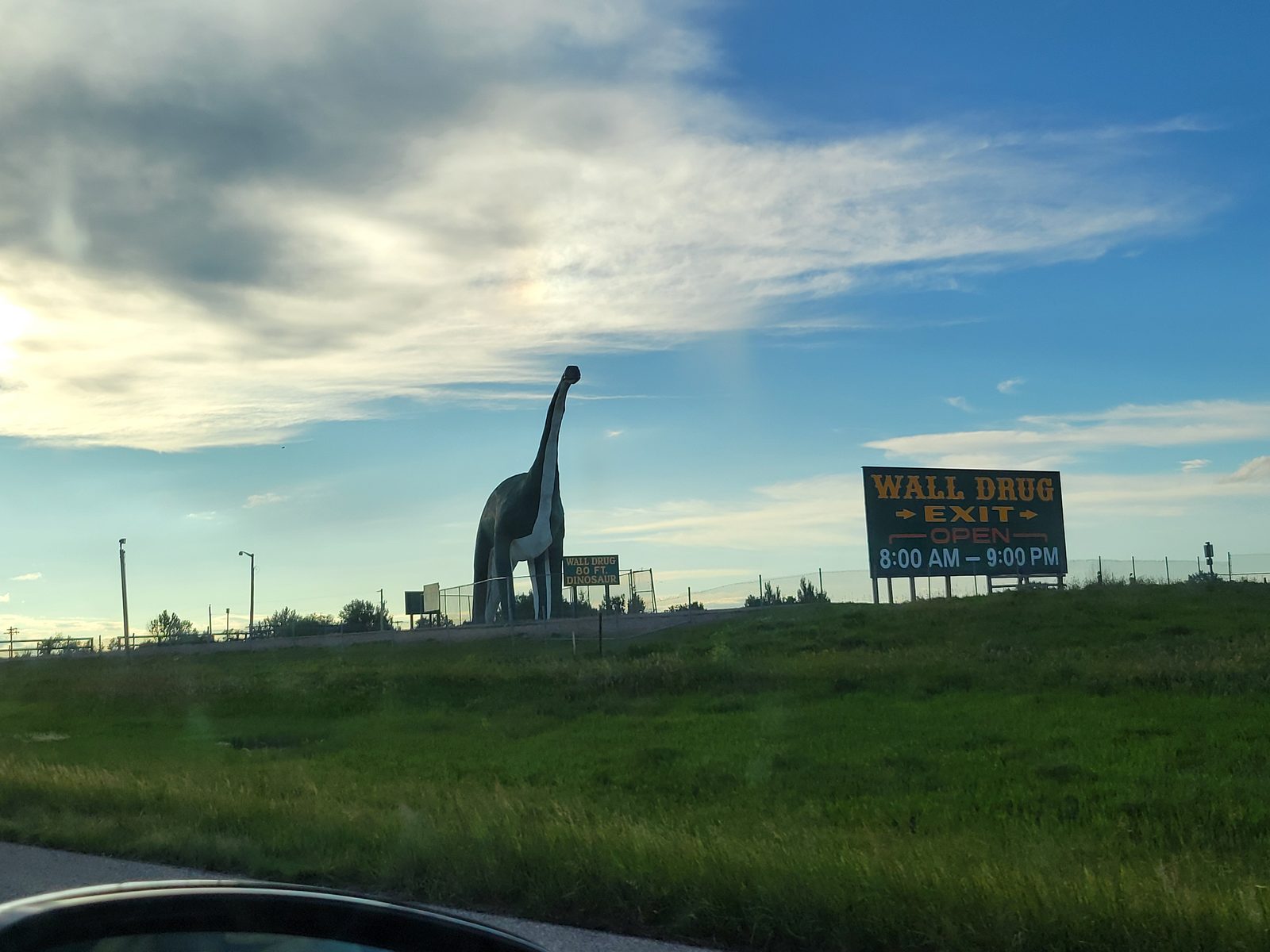 A dinosaur marks the Wall Drug exit