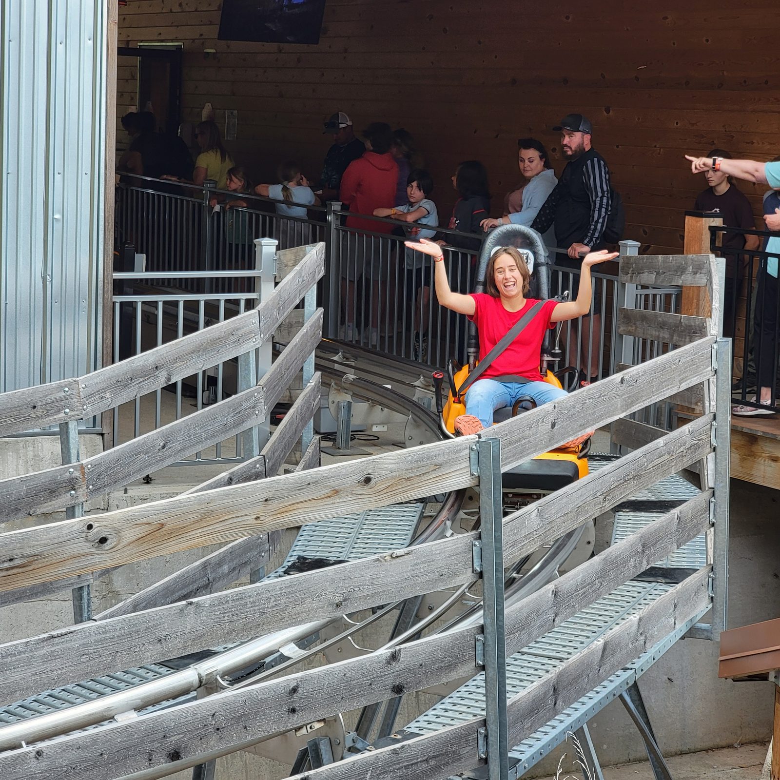Lisa with her arms up at the coaster station