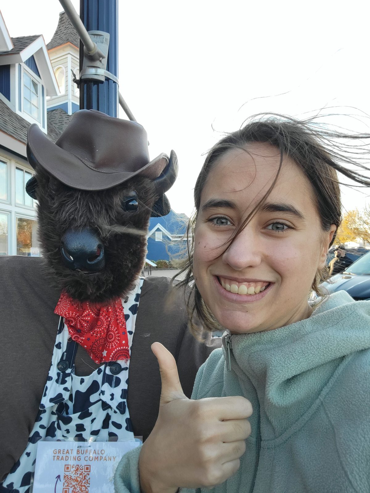 Lisa thumbs up with the buffalo mascot in Mackinaw City