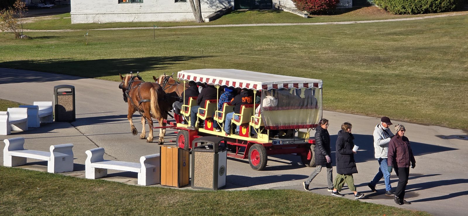 The horse-drawn carriage crossing the fort's green