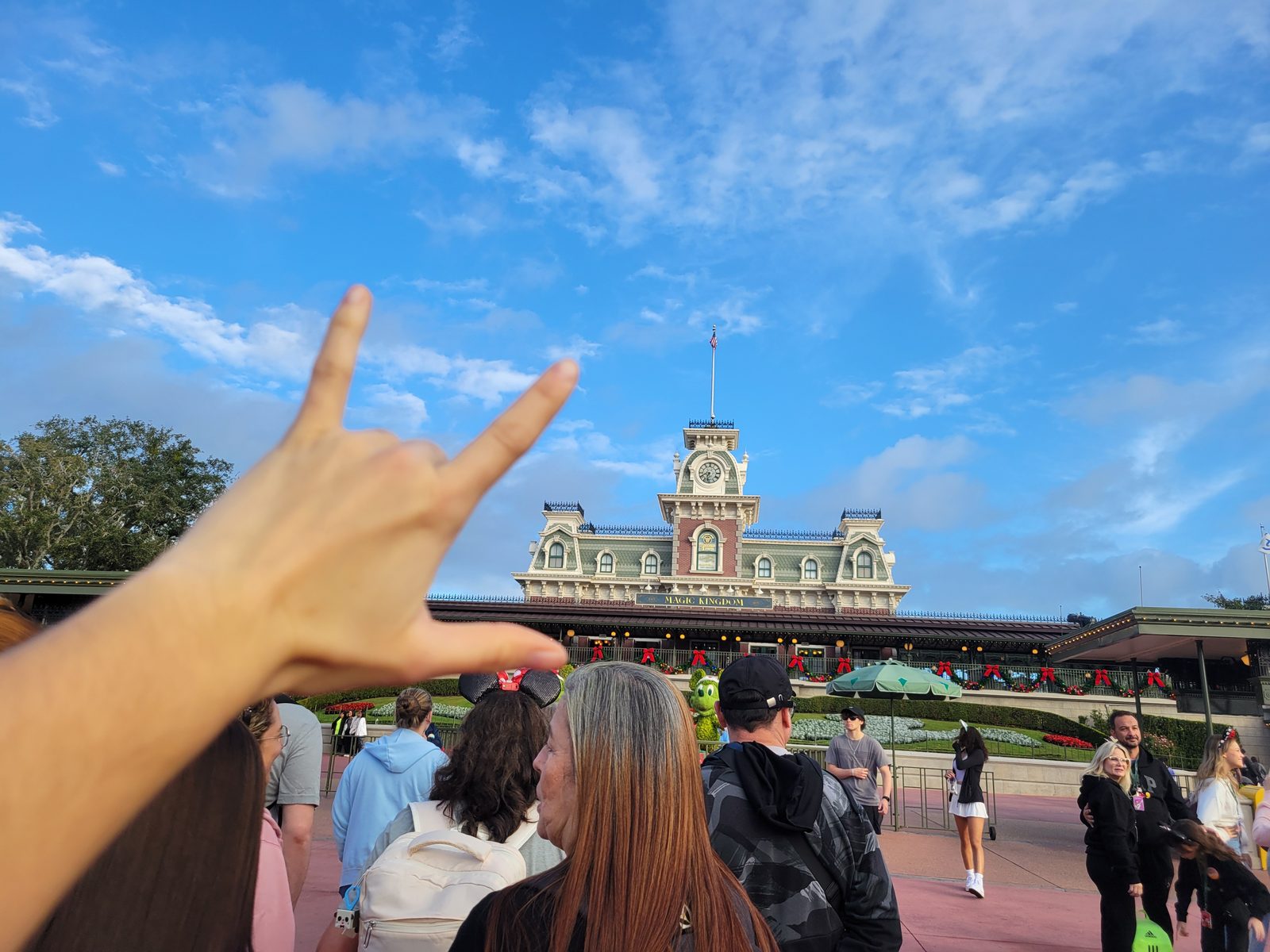 Lisa signs I love you at the Magic Kingdom gates
