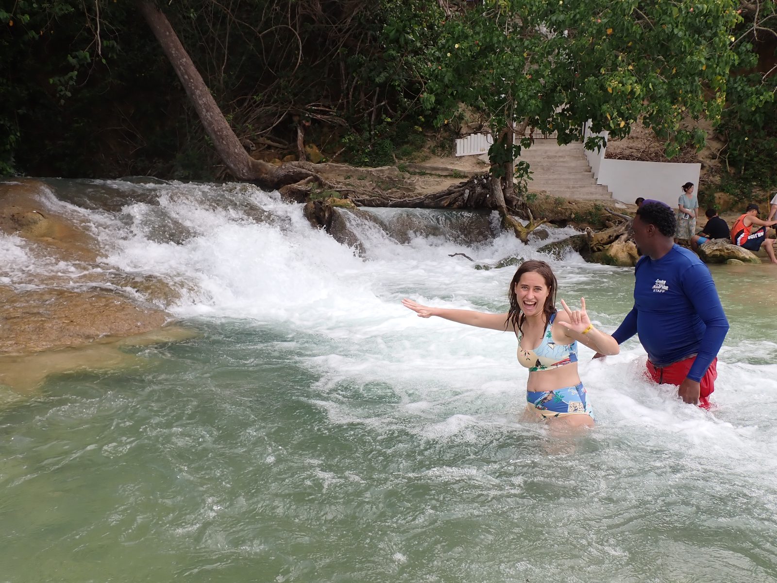 Lisa crossing the falls with a guide