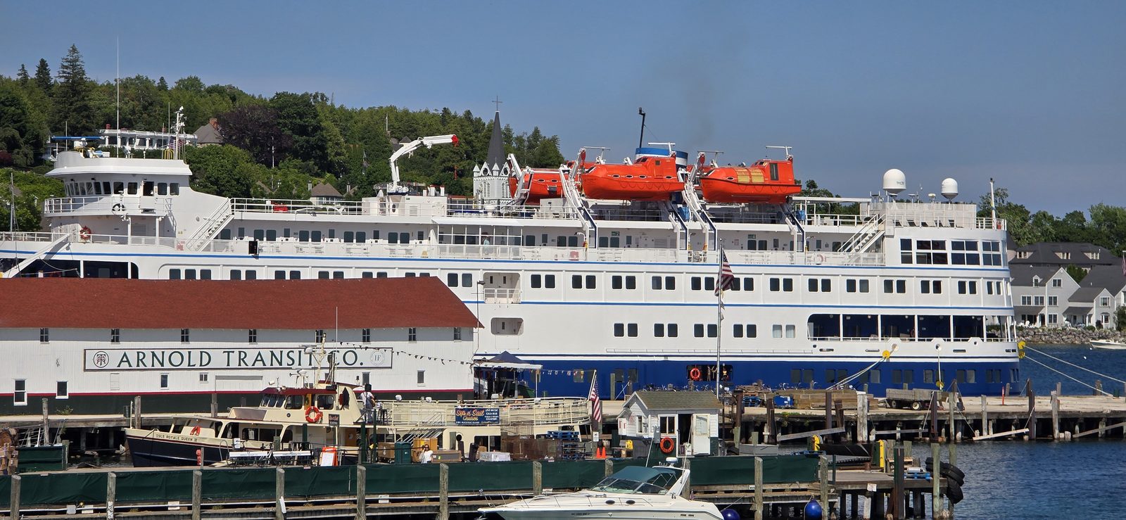 A small cruise ship docked behind the Arnold Transit pier