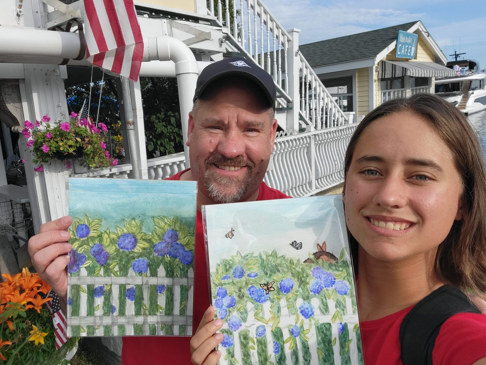 Holding their finished flower paintings