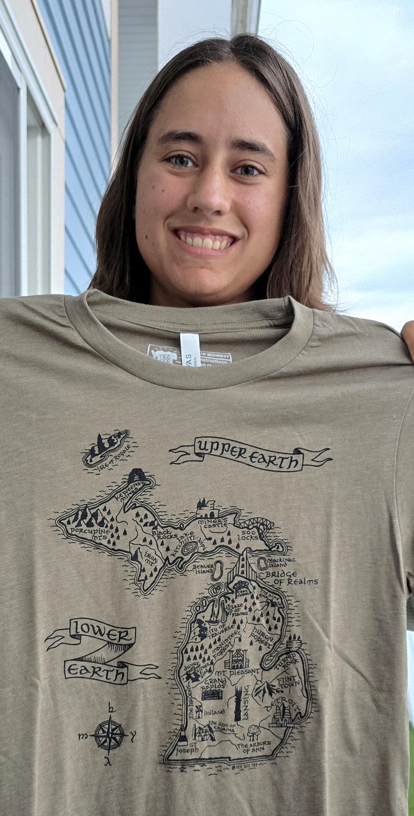 Lisa holding up her new Michigan map T-shirt