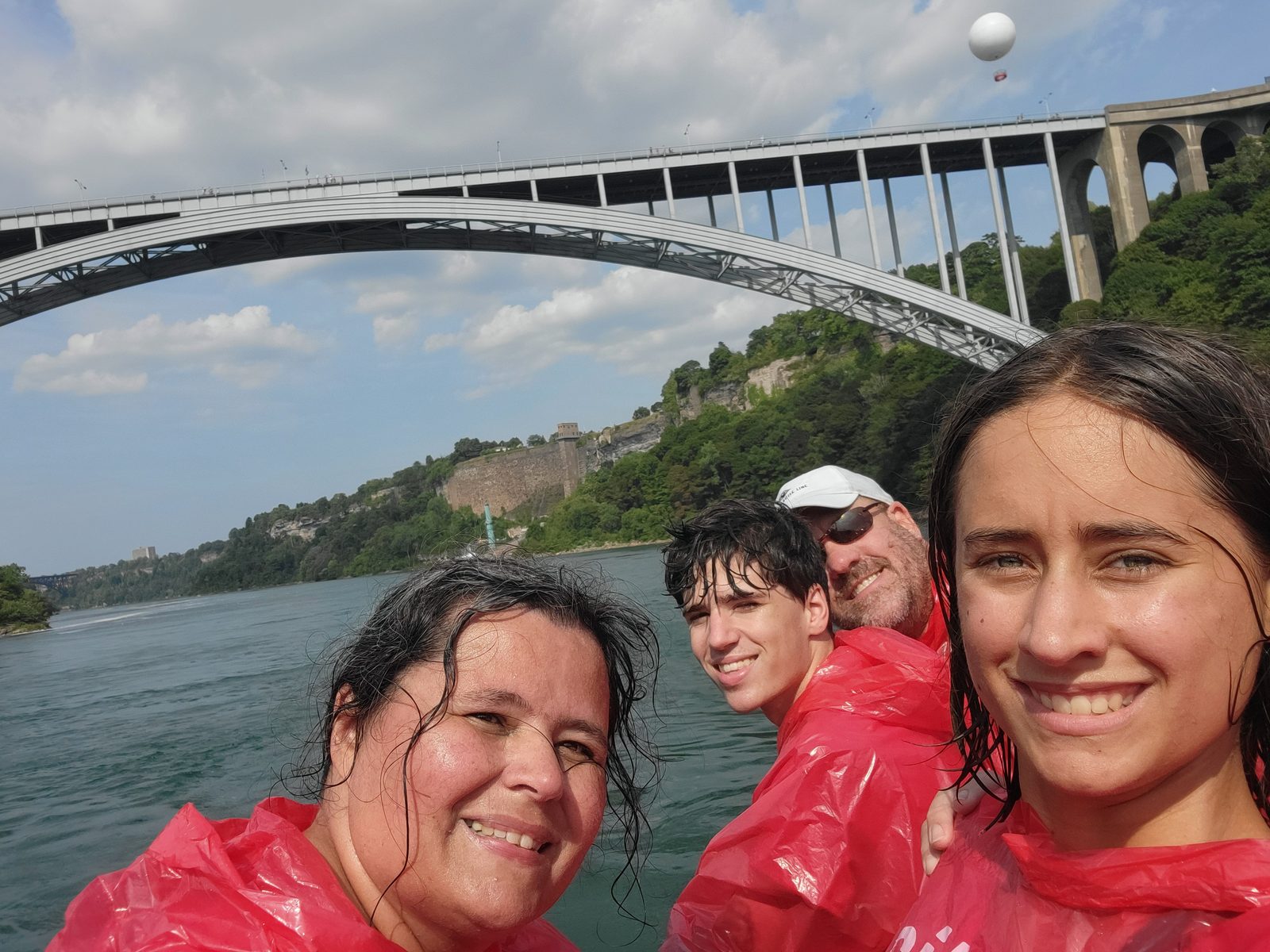The whole family, soaked, on the boat