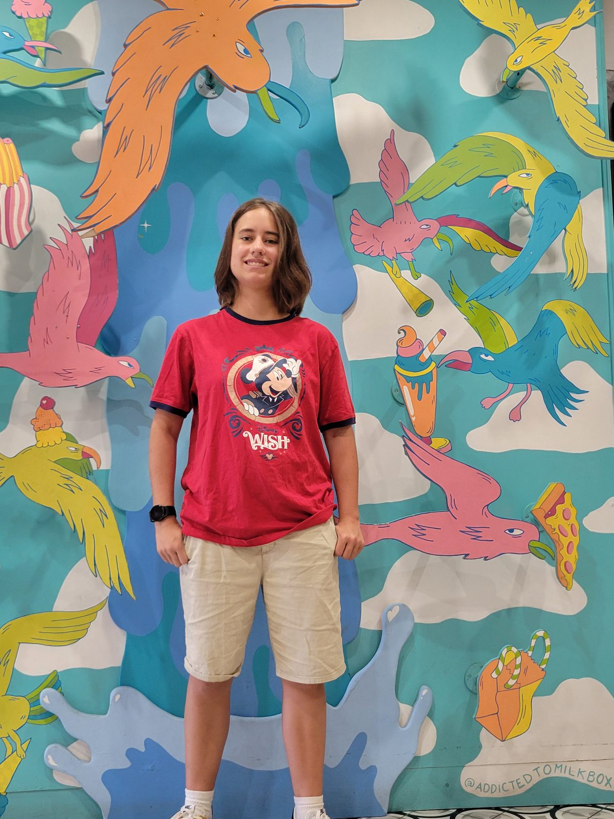 Lisa in front of a colorful mural
