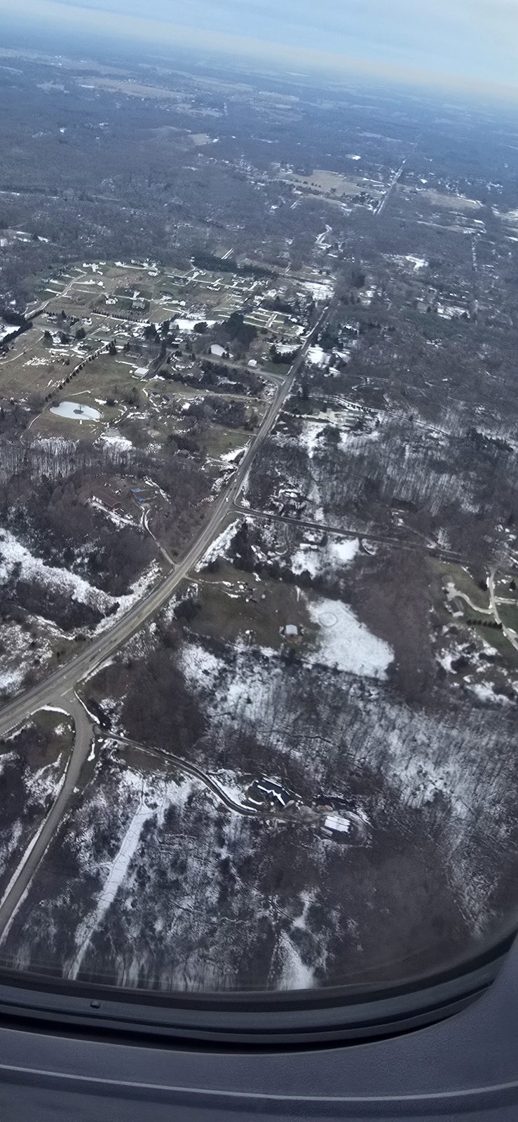 Snow-covered Michigan falling away below us