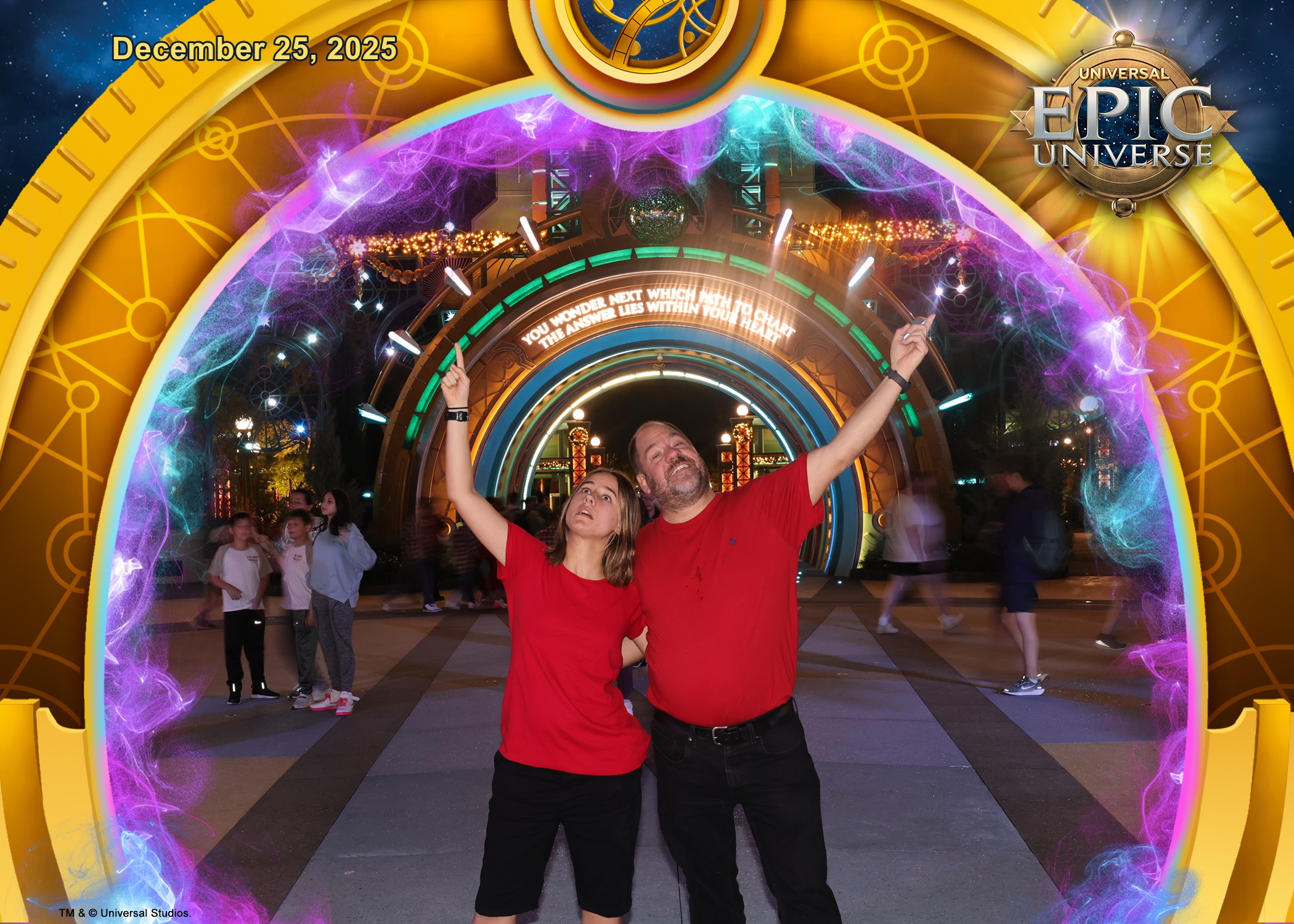 Lisa and Michael, arms up at the portal after dark