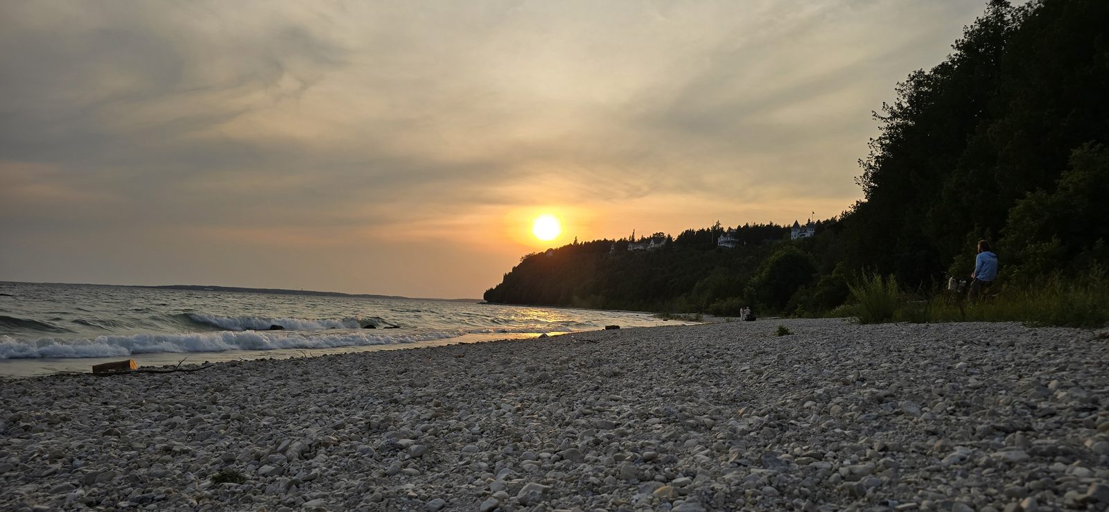 The sun going down over the rocky shore