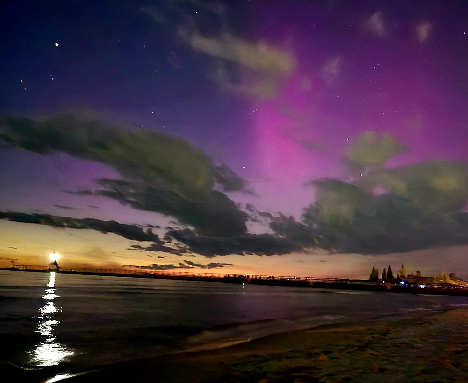 Northern lights behind the clouds over the St. Joseph pier