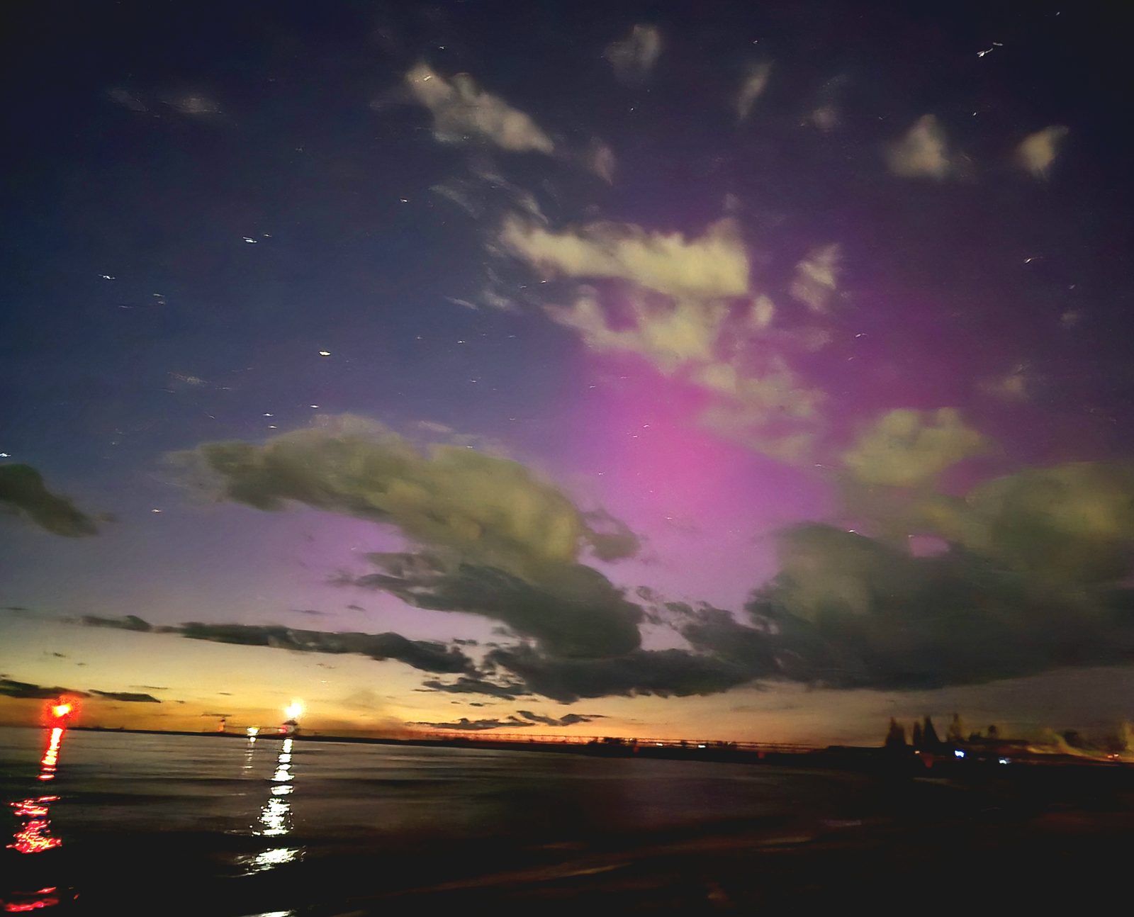 Northern lights glowing through the clouds after dark