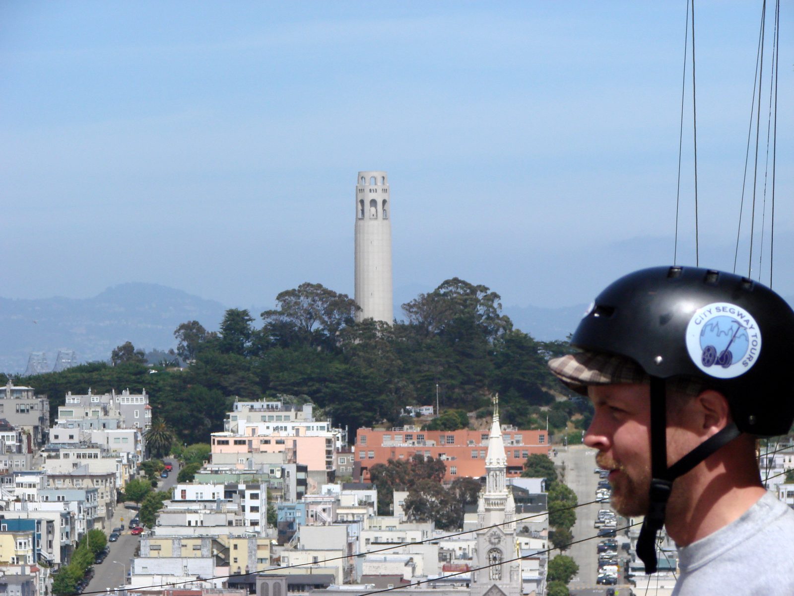 A Segway tour rider below Coit Tower