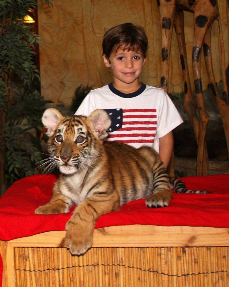 Thomas holds the tiger cub