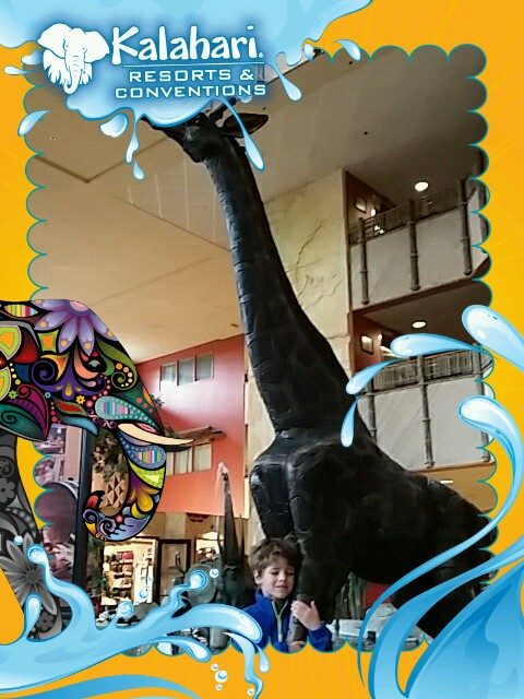 Thomas and the giraffe statue, a Kalahari souvenir photo