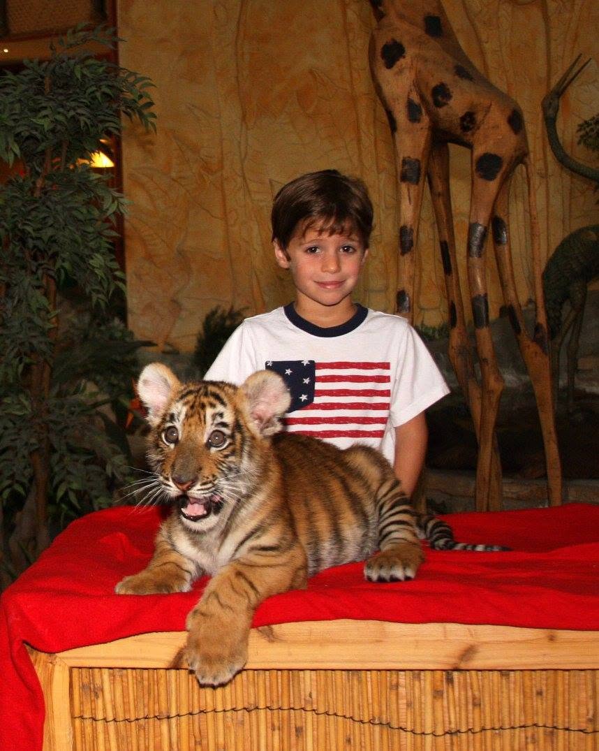 Thomas with Zahdee, the tiger cub, at Kalahari