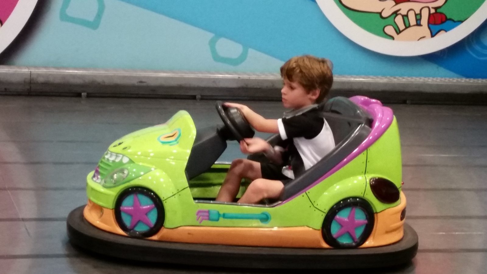 Thomas drives the green Reptarmobile bumper car