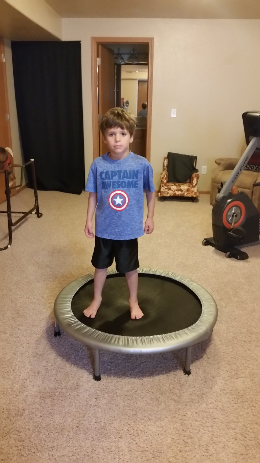 Thomas jumps on the mini trampoline at the house