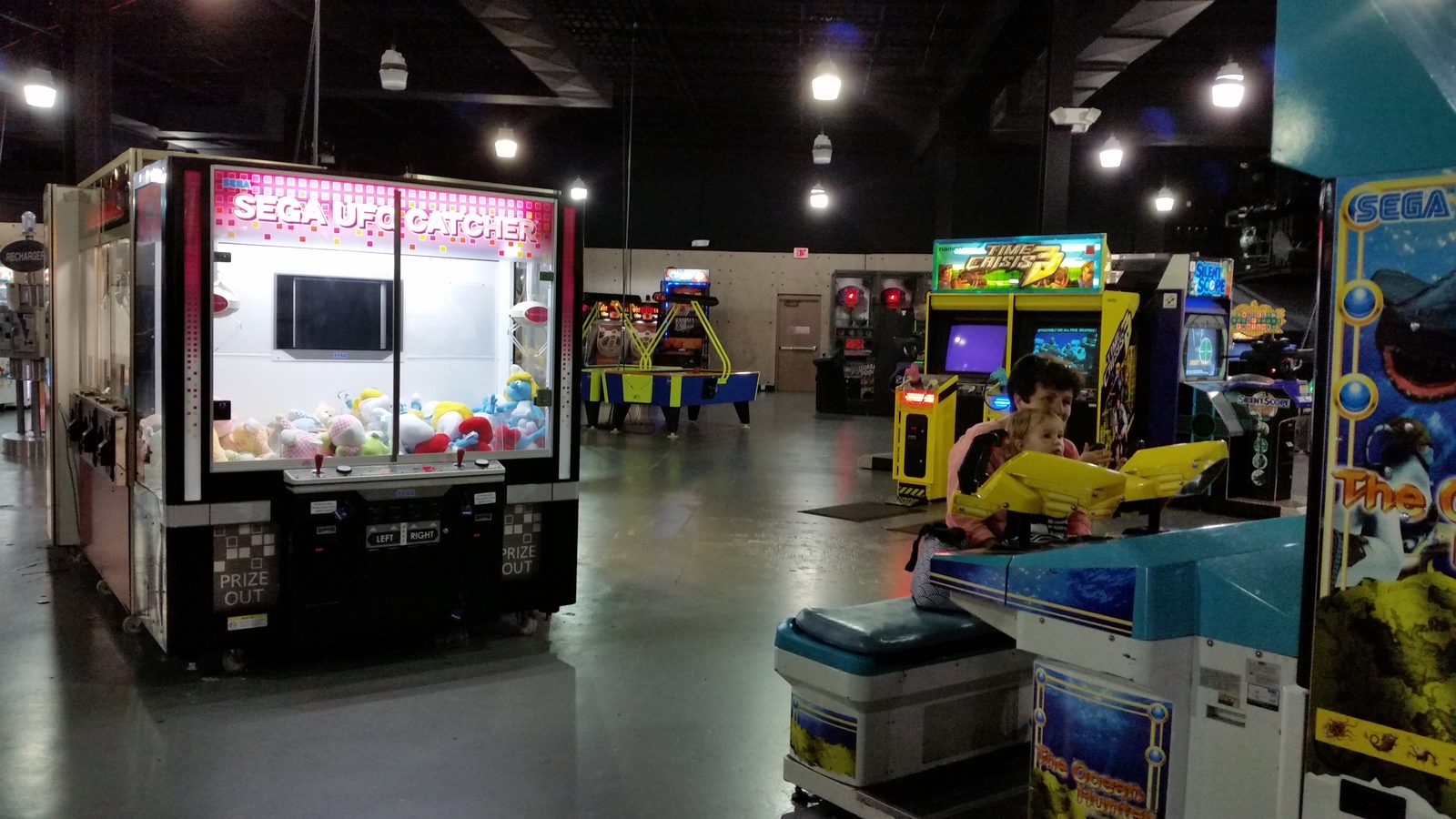 Claw machines line the arcade floor