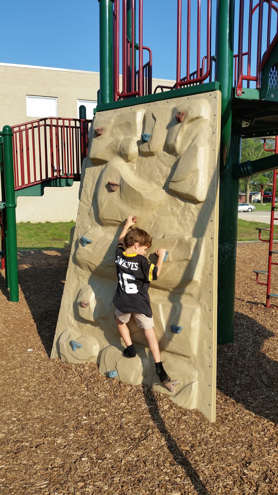 Thomas scales the rock climbing wall