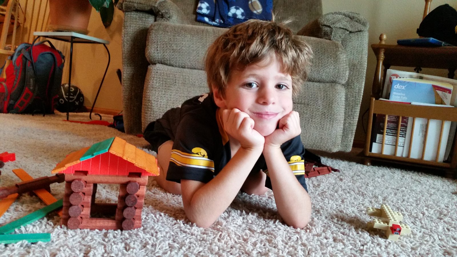 Thomas beside his finished log cabin