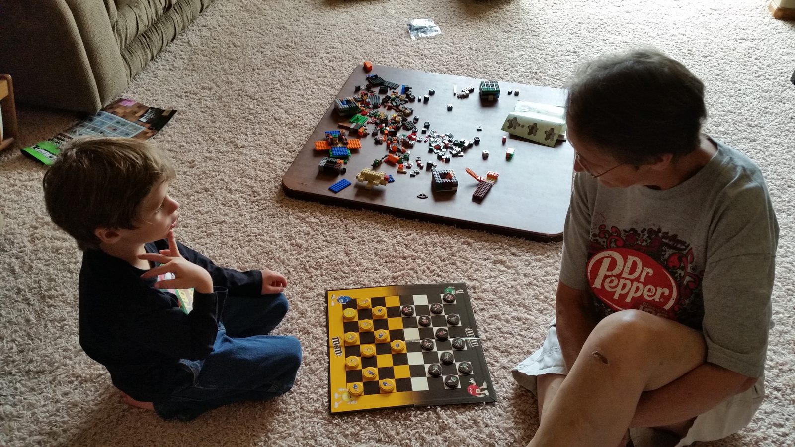 Thomas playing checkers on the floor