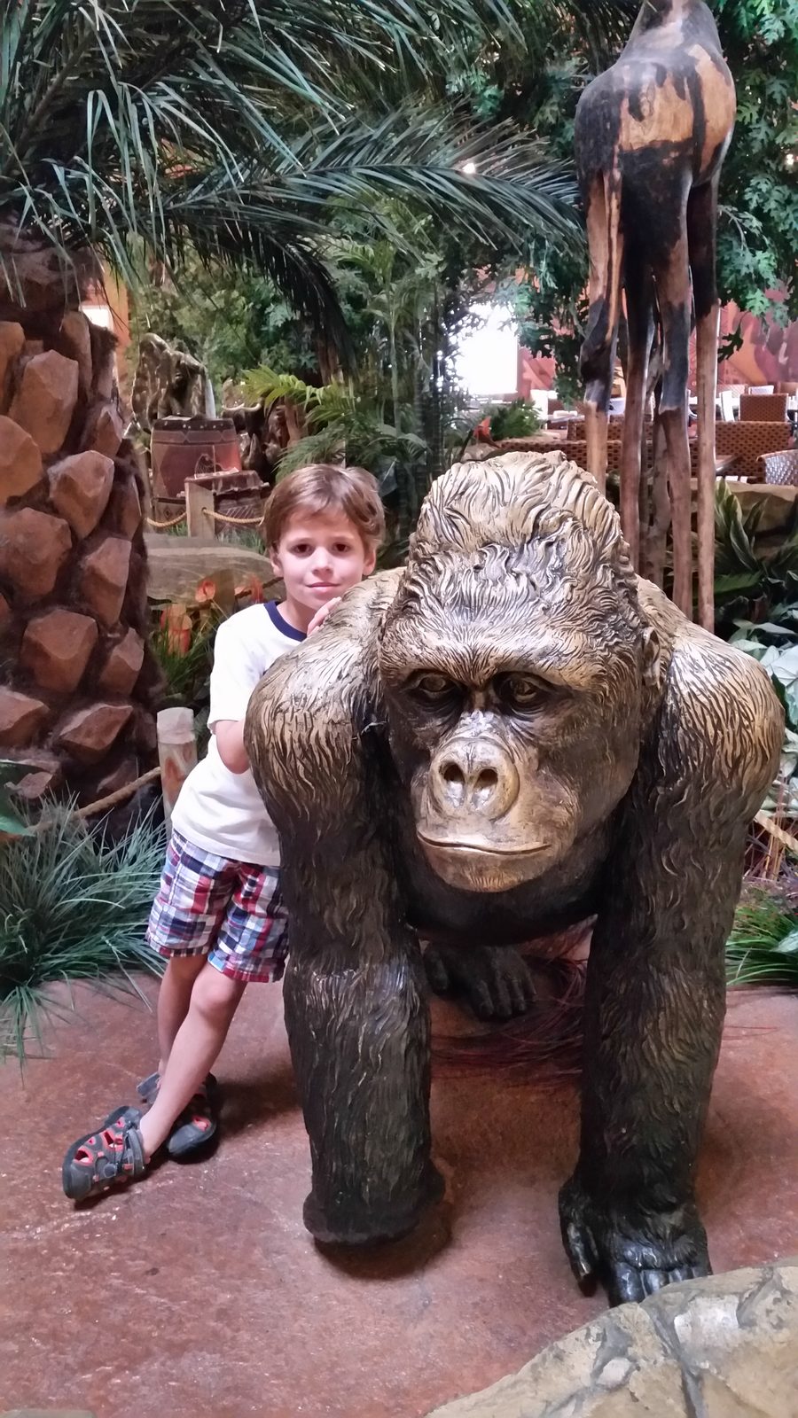 Thomas beside the lobby's gorilla statue