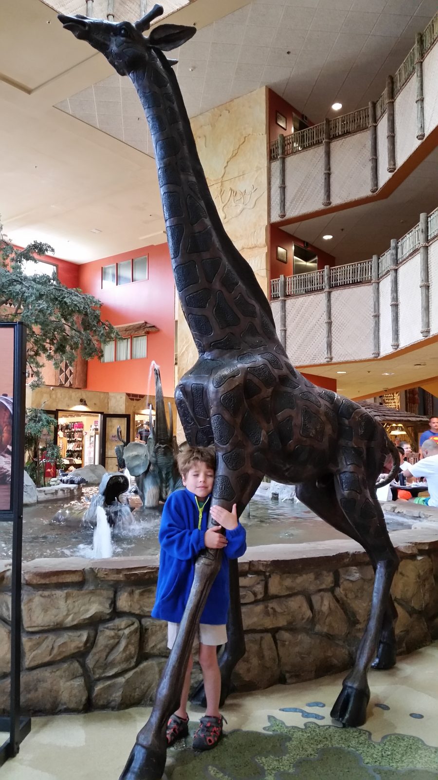 Thomas beside the bronze giraffe statue