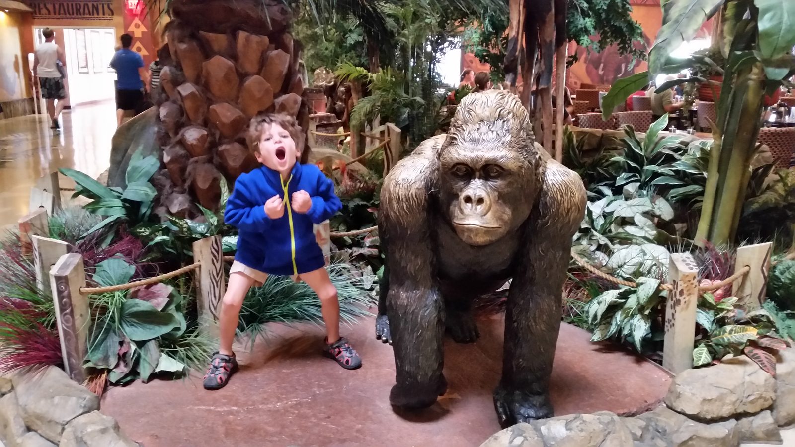 Thomas roars beside the gorilla statue