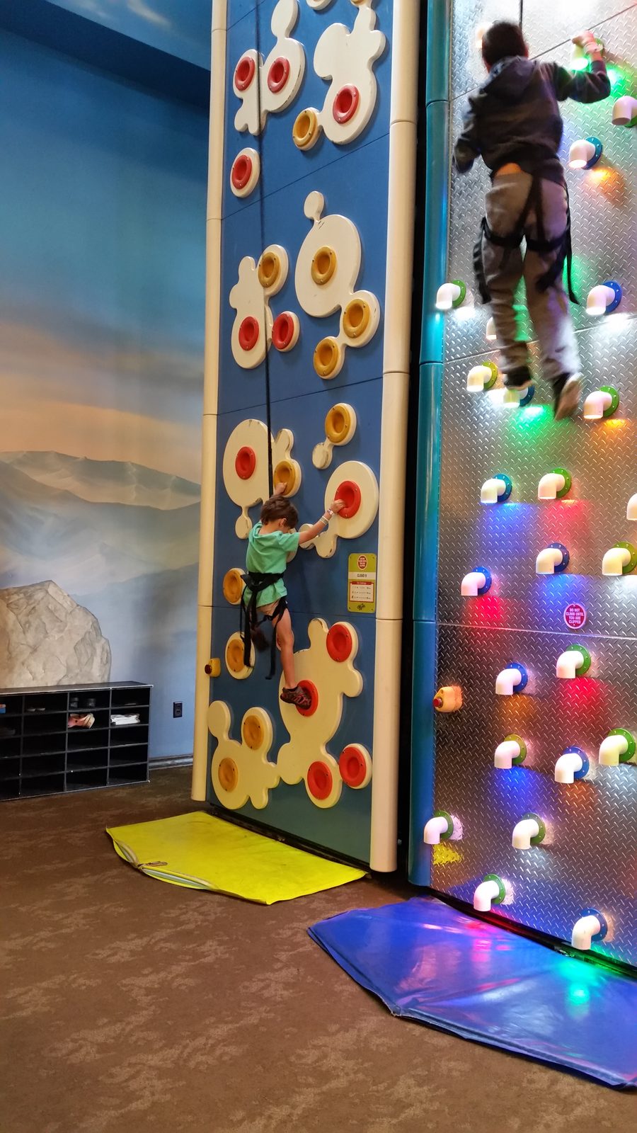 Thomas climbs the indoor rock wall