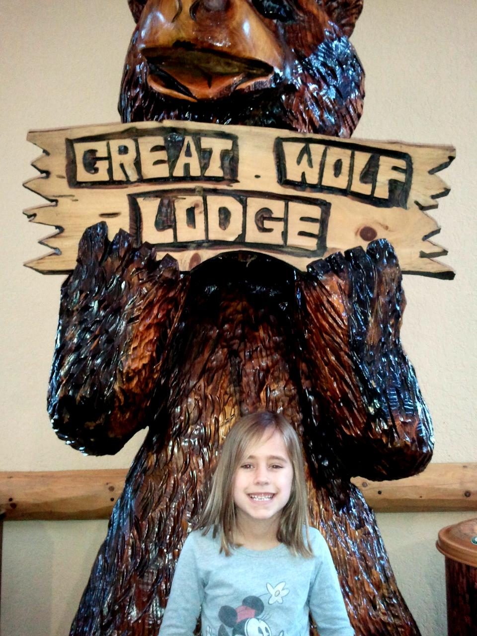 Lisa poses with the big wolf statue in the lobby