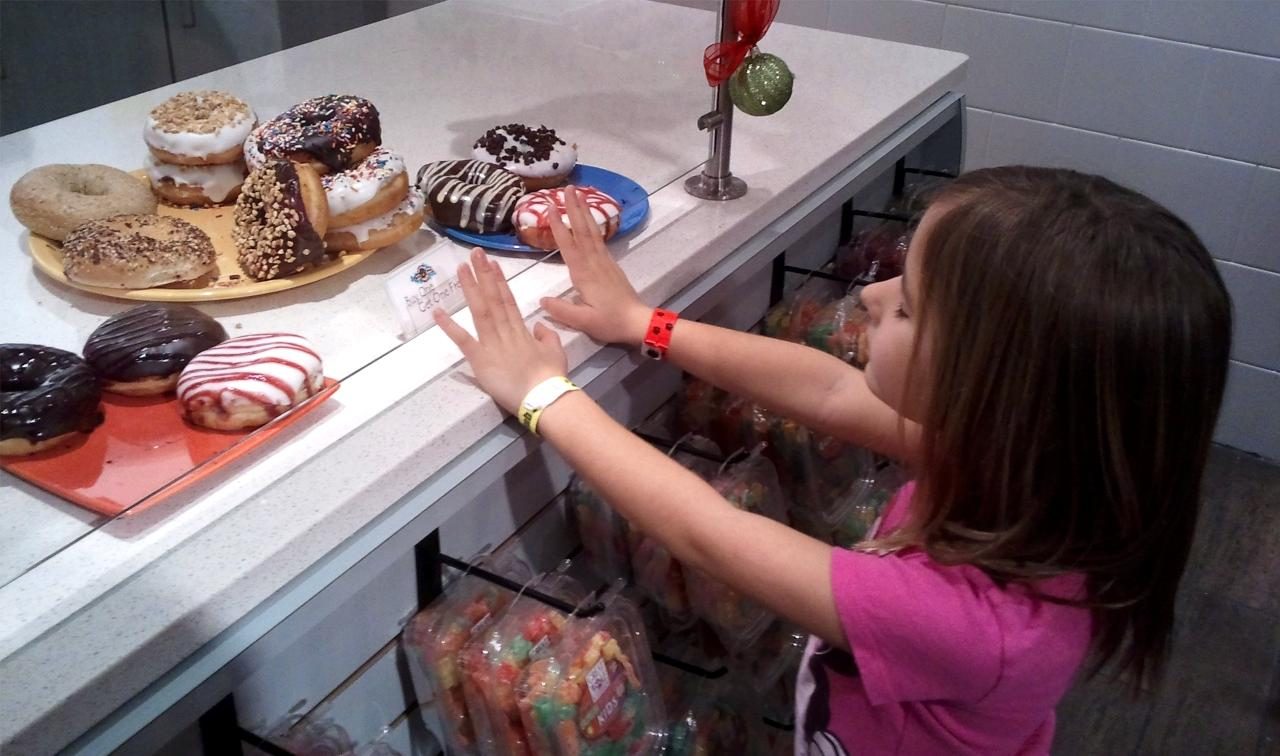 Lisa reaching for donuts at breakfast