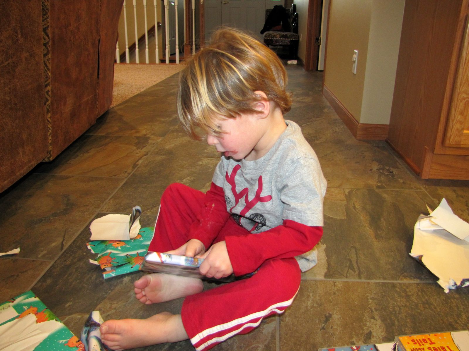 Thomas sitting in a pile of wrapping paper