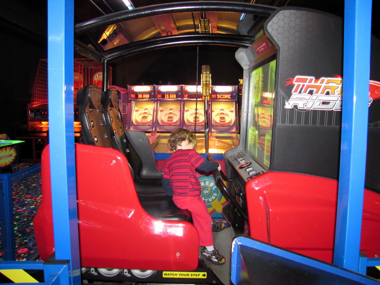 Thomas driving the little arcade race car