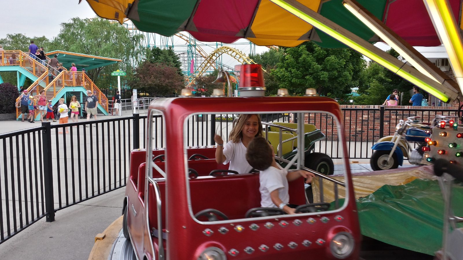 Lisa driving the kiddie car with Thomas