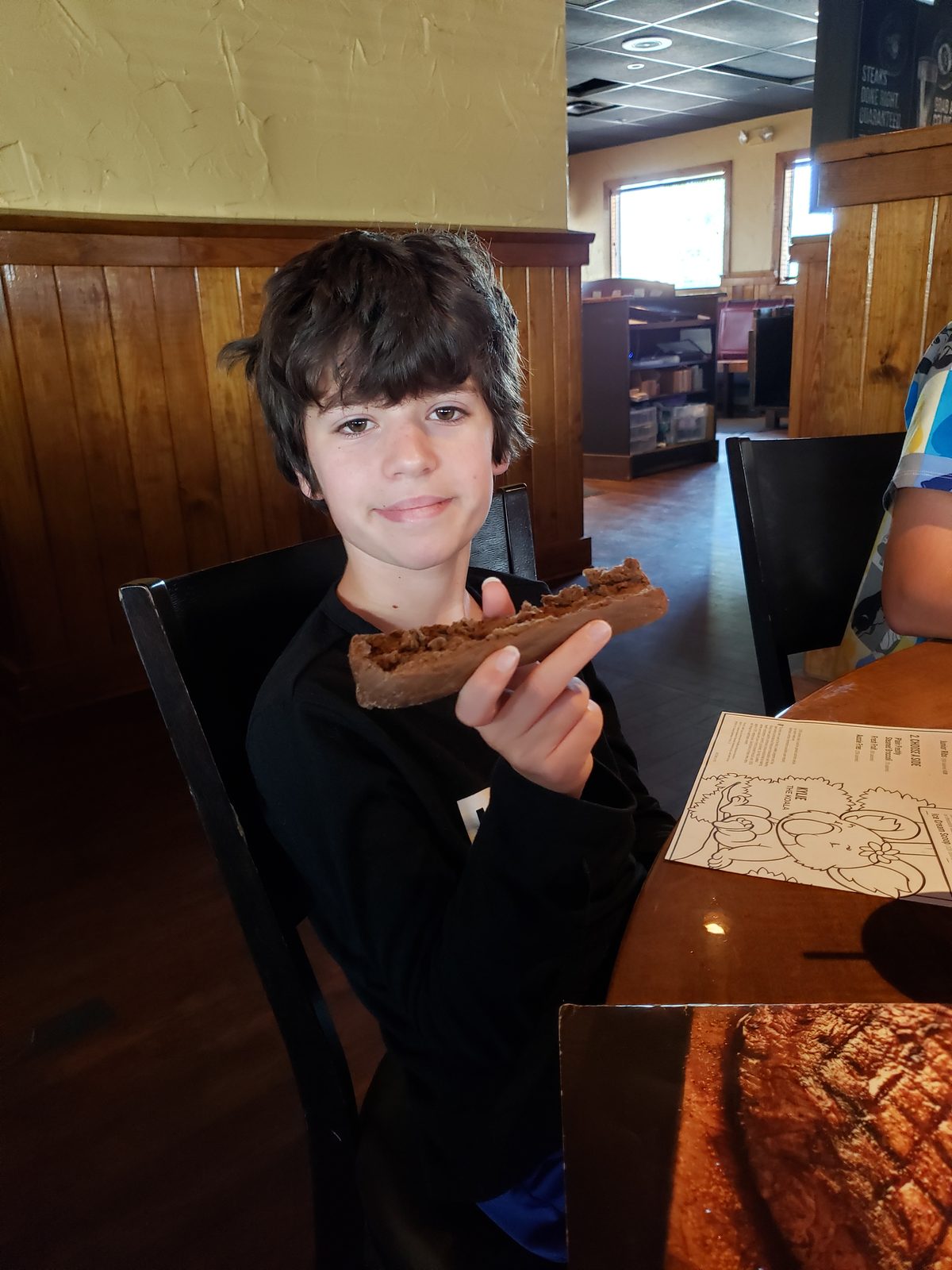 Thomas digs into a sandwich