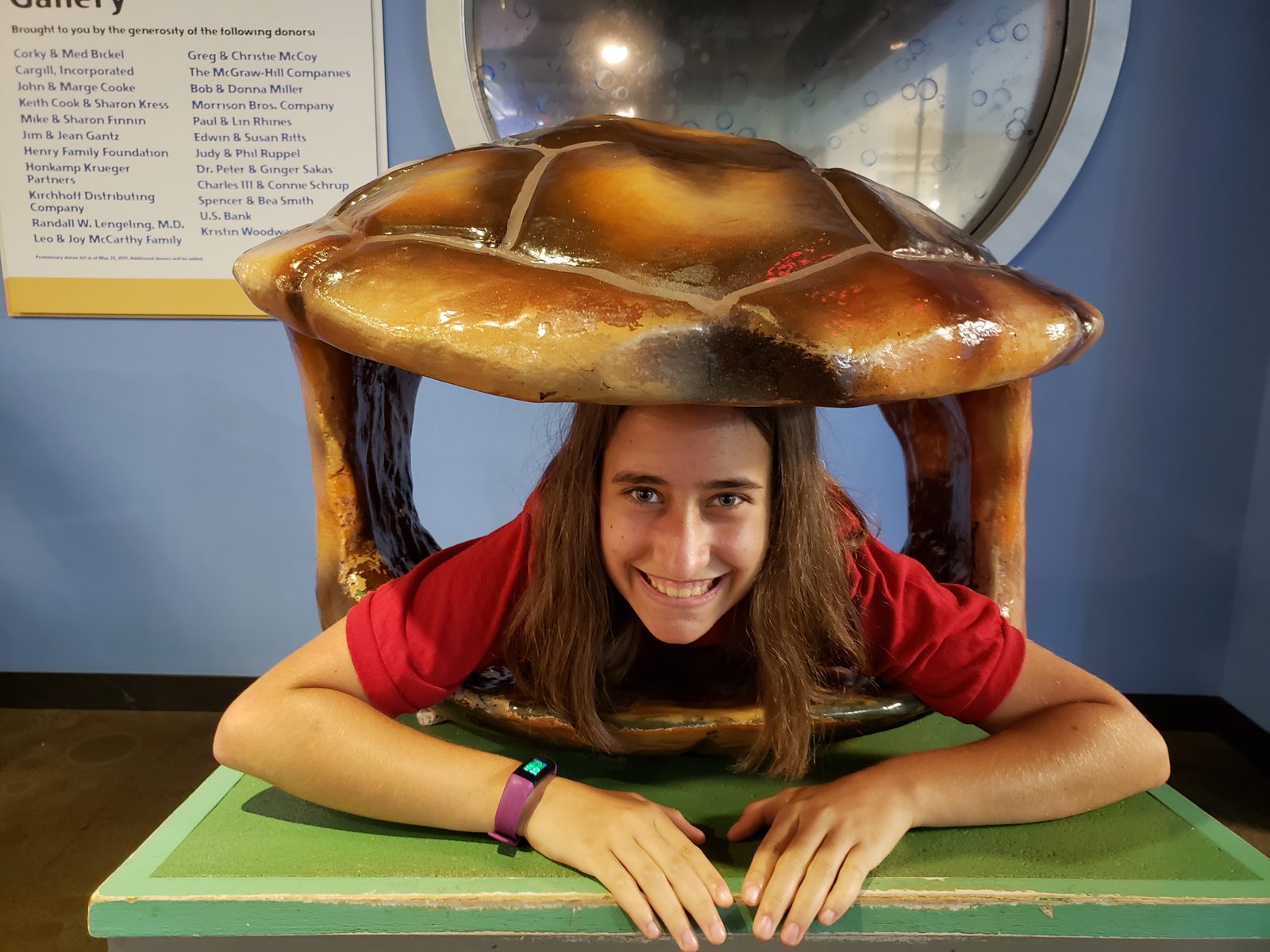 Lisa climbs into the giant turtle shell