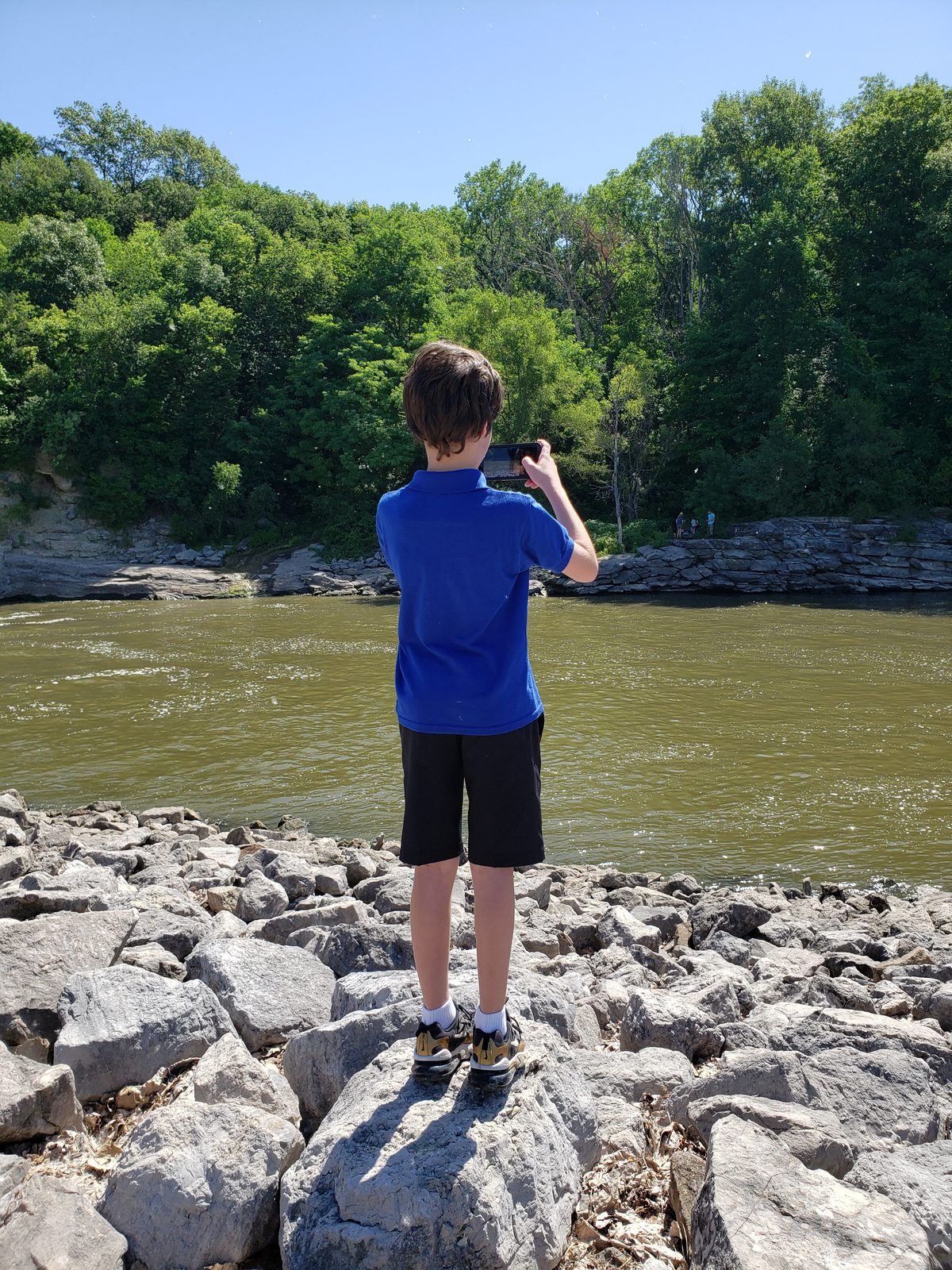 Thomas photographs the river's edge