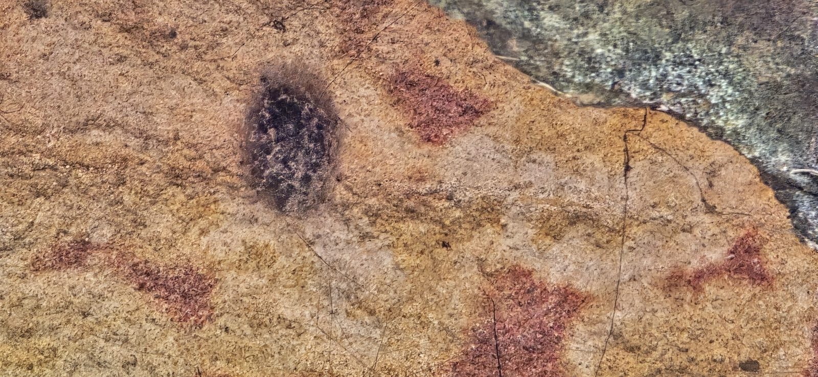Rust-coloured markings on the sandstone