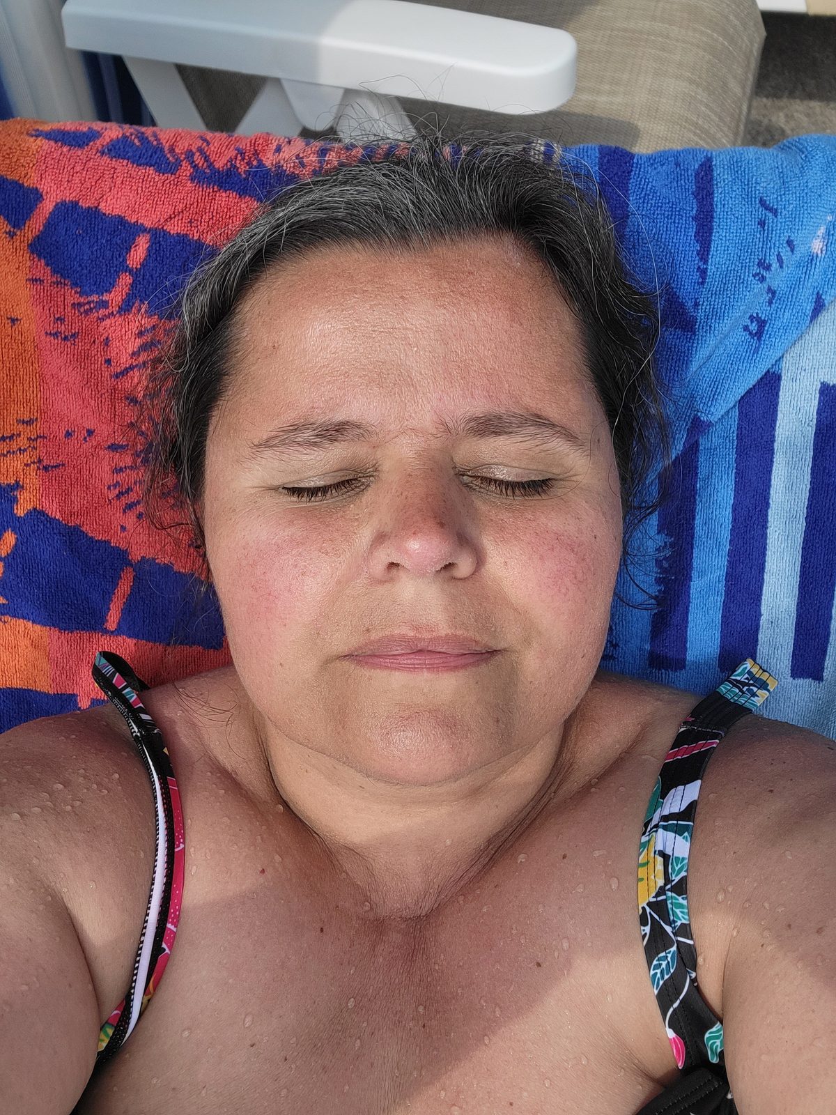 Kathy catching some sun at the cabana