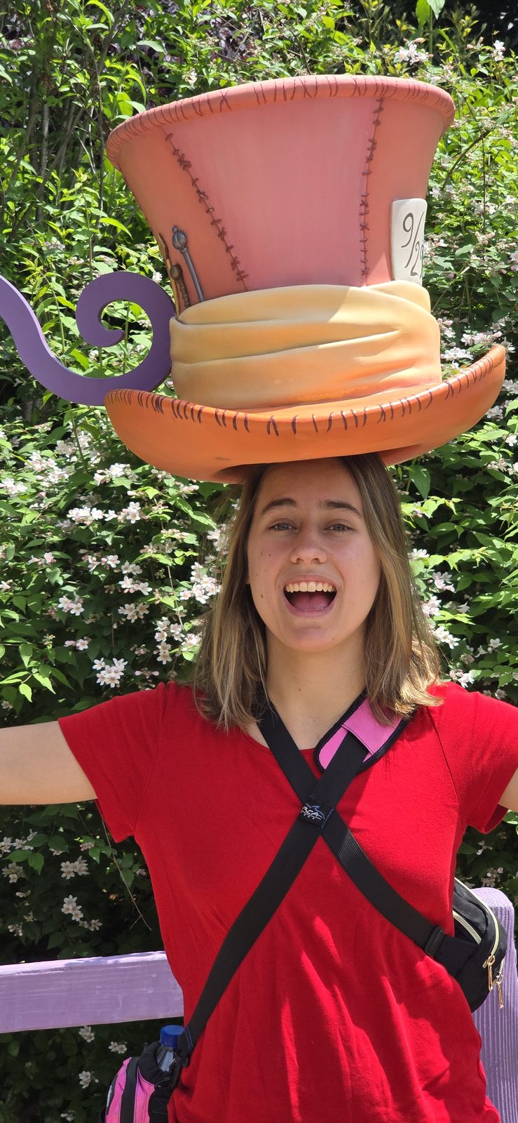 Lisa under a giant Mad Hatter hat at Shanghai Disneyland